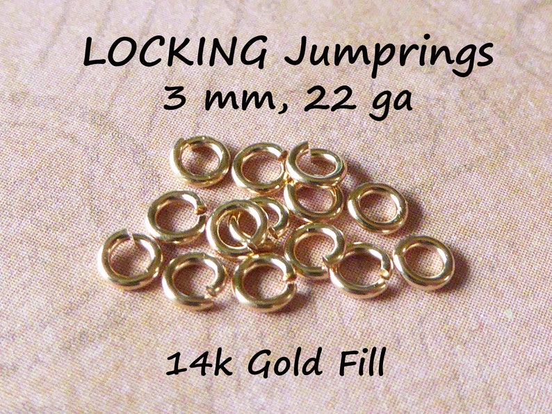 May include: A close-up of 14k gold filled jump rings. The rings are 3 mm in diameter and 22 gauge.  LOCKING Jump rings, 3 mm, 22 ga, 14k Gold Fill.
