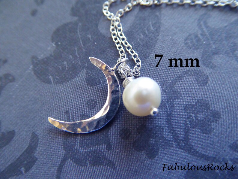 May include: A silver crescent moon charm necklace with a 7 mm white pearl pendant. The charm has a hammered texture.
