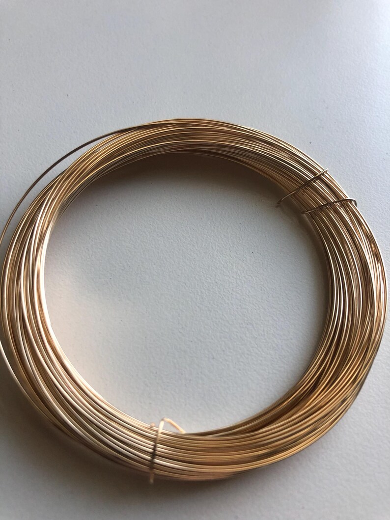 May include: A coil of gold-colored wire, perfect for jewelry making or crafting projects.