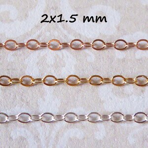 Puede incluir: Tres hebras de cadena, de 2x1,5 mm de tama&ntilde;o, en oro rosa, oro y plata. Las cadenas est&aacute;n dispuestas horizontalmente sobre un fondo de tela blanca.