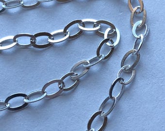 May include: A silver chain necklace with oval links. The chain is made of metal and has a polished finish.