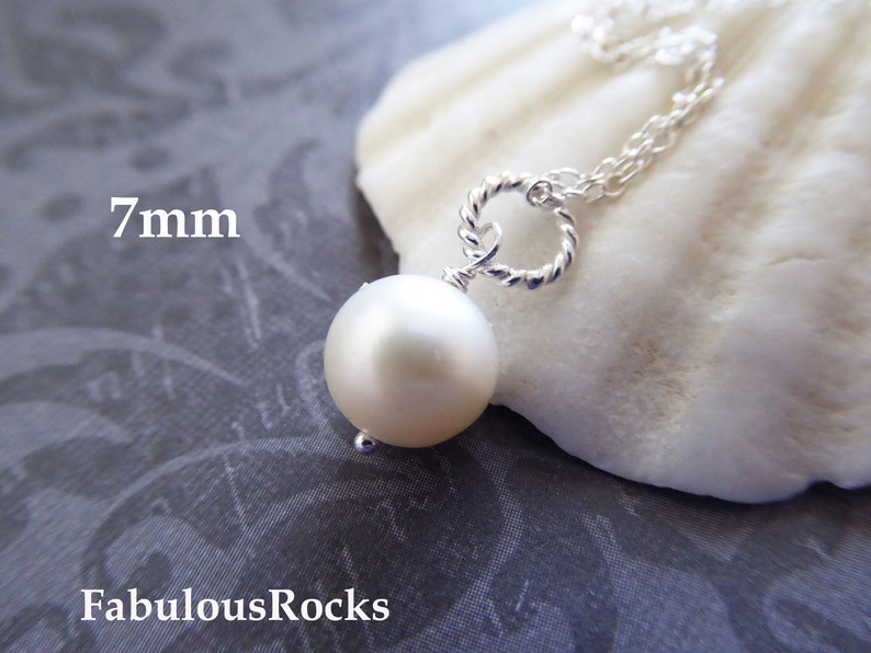 May include: A silver chain necklace with a 7mm white pearl pendant. The pearl is attached to the chain with a twisted silver wire.