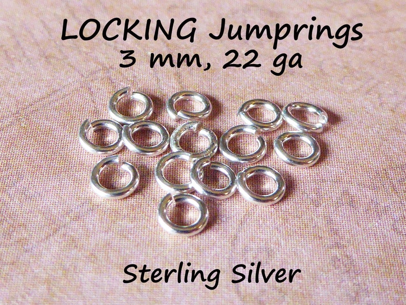 May include: A close-up of a pile of silver locking jump rings. The rings are 3 mm in diameter and 22 gauge. The text "LOCKING Jumprings 3 mm, 22 ga Sterling Silver" is visible in the image.