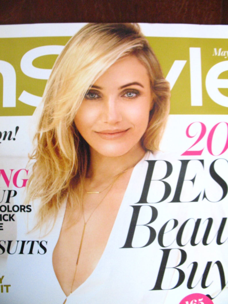 May include: A magazine cover featuring a woman with blonde hair wearing a white top and a gold necklace. The magazine cover text reads "InStyle" and "20 Best Beauty Buys".