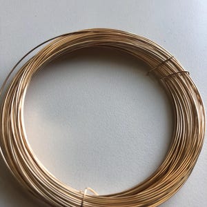 May include: A coil of gold-colored wire, perfect for jewelry making or crafting projects.