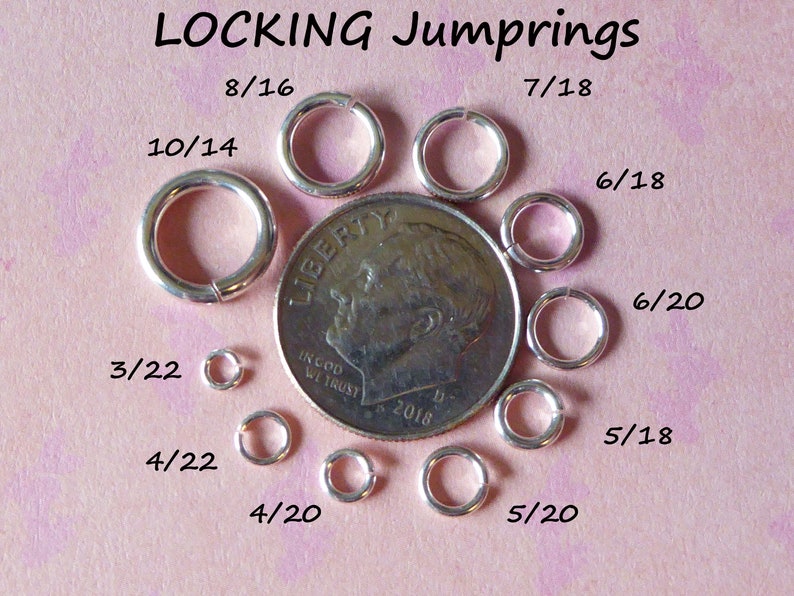 May include: A close-up of a variety of silver locking jump rings, ranging in size from 3/22 to 8/16 inches. The jump rings are arranged around a US dime for size comparison.