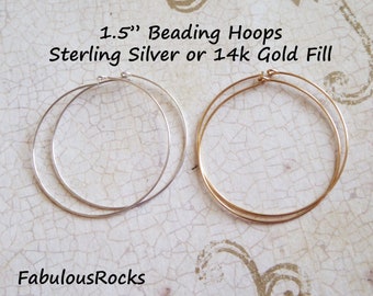 May include: Two 1.5 inch beading hoops, one sterling silver and one 14k gold fill. The hoops are shown on a white textured surface.