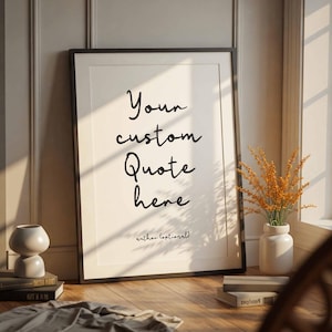 May include: A framed print with the text "Your custom Quote here" in a black frame. The print is leaning against a wall, with a vase of dried flowers and a small sculpture nearby. The text "author (optional)" is below the quote.