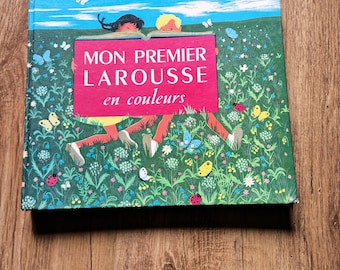 May include: A hardcover children's book titled "MON PREMIER LAROUSSE en couleurs" with a colorful illustration of children in a field with butterflies and flowers. The book has a red rectangular title box.