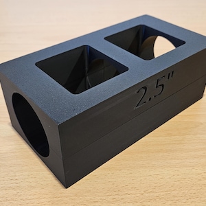 May include: Black plastic mold with two square openings and a round opening. The mold is labeled "2.5" inches.