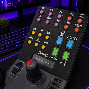 Könnte beinhalten: Ein schwarzes Gaming-Steuerpult mit einem Joystick, einem Scrollrad und einem Raster aus bunten Tasten. Die Tasten sind in Reihen und Spalten angeordnet und mit verschiedenen Symbolen sowie weißen Beschriftungen wie PTO, Fold, Unfold, SEED und AUTO versehen.