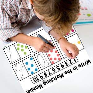 May include: A black and white worksheet with a dotted number line and a section for writing in the matching number. The worksheet is designed for children to practice counting and number recognition.