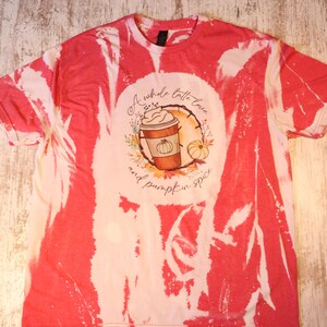 May include: A red and white tie-dye t-shirt with a graphic of a coffee cup with whipped cream and the text "A whole lotta love and pumpkin spice".