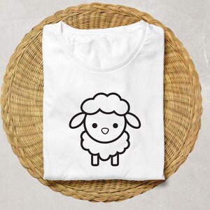 May include: White t-shirt with a black and white cartoon sheep illustration.