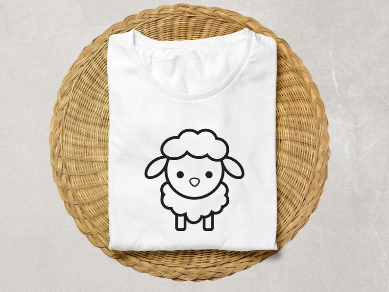 May include: White t-shirt with a black and white cartoon sheep illustration.