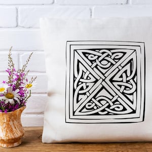 May include: White throw pillow with a black and white Celtic knot design. The knot is in the center of the pillow and is surrounded by a black border.