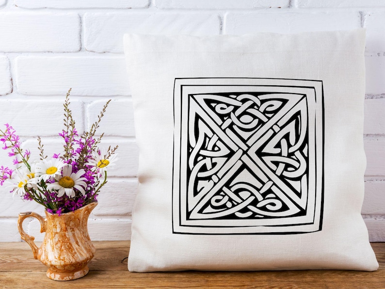May include: White throw pillow with a black and white Celtic knot design. The knot is in the center of the pillow and is surrounded by a black border.