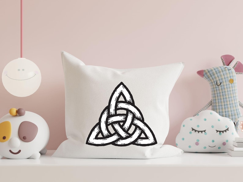 May include: A white pillow with a black Celtic knot design. The knot is a traditional symbol of love, friendship, and unity.