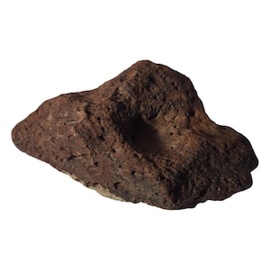 May include: A rough, reddish-brown stone with a natural, porous texture. The stone has a shallow, bowl-like indentation on its surface. The overall shape is irregular and organic, suggesting a handcrafted or natural origin.
