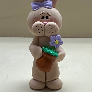 Standing tan bunny with a flower