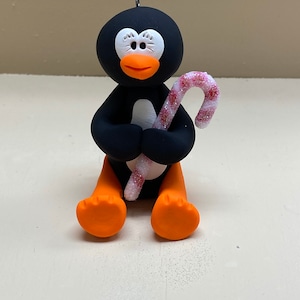 Penguin with a candy cane ornament