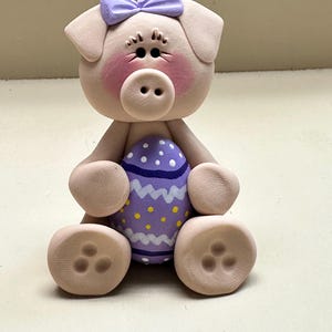 Pig holding a Easter egg