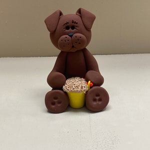 Brown dog with a bucket of sand