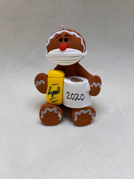 Gingerbread ornament holding toilet paper and Lysol