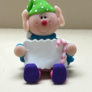 Elf with a candy cane ornament
