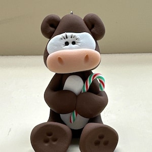 Hereford cow with a candy cane ornament
