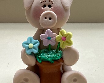 Pig with a pot of  flowers