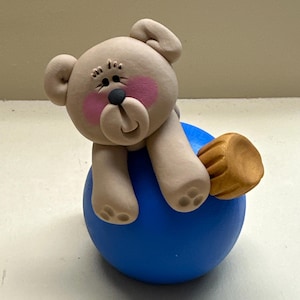Teddy bear on a Christmas bulb decoration
