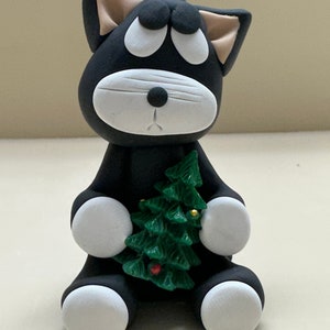 Black and white dog with a Christmas tree ornament