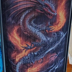 May include: A book cover with a black dragon with orange flames on a black and orange background.