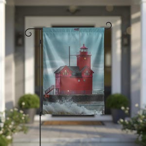 May include: A rectangular garden flag featuring a vibrant red lighthouse structure with a dark roof and a small lantern room at the top. The lighthouse stands on a dark pier with white ocean waves crashing against the base under a cloudy sky.