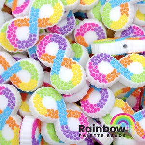 May include: A close-up of a pile of white silicone beads with a rainbow pattern of small hearts. The beads are shaped like the infinity symbol. The text "Rainbow Palette Beads" is visible at the bottom of the image.