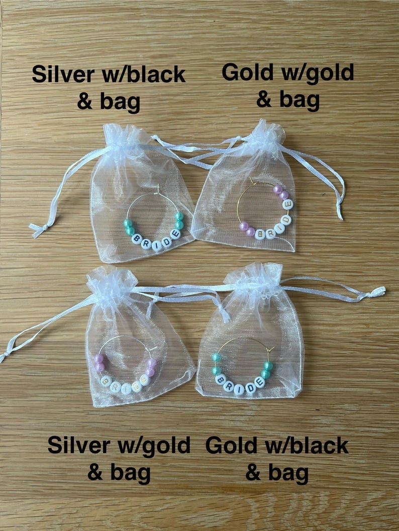 May include: Four hoop earrings with white letter beads spelling BRIDE, each inside a sheer white drawstring bag. The top left is silver with teal beads, top right is gold with pink beads, bottom left is silver with pink beads, bottom right is gold with teal beads.