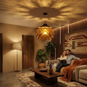 May include: A living room scene featuring a large, leaf-shaped pendant light casting a warm glow. A couple sits on a beige sofa, reading a book. The room includes a wooden coffee table, a floor lamp, and a patterned rug, creating a cozy atmosphere.