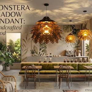 May include: Monstera Shadow Pendant handcrafted from wood, hanging in a cafe setting. The pendant lights are shaped like monstera leaves, casting leaf-shaped shadows. The cafe has a tropical theme with green plants and a long green bench.