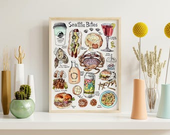 May include: A framed print titled "Seattle Bites" featuring hand-drawn illustrations of local food and drinks, including coffee, a hot dog, crab, and a cocktail. The print is displayed on a white shelf with decorative vases and yellow floral accents.