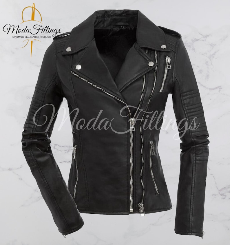 May include: Black leather motorcycle jacket with a zipper closure and multiple pockets. The jacket has a classic biker style with a stand-up collar and a slightly fitted silhouette.
