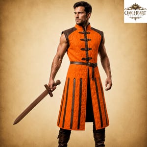 May include: A sleeveless orange quilted tunic featuring dark brown leather trim, vertical panels, and a front closure with multiple buckled straps. The garment is worn with dark brown boots and is paired with a brown sword held in the right hand.
