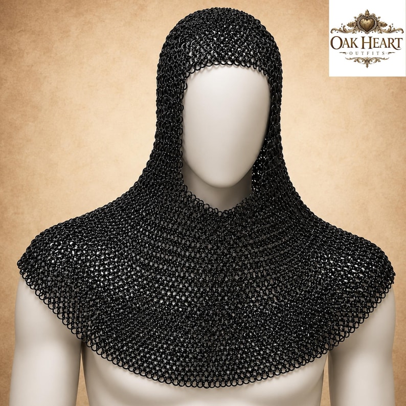 May include: Black chainmail coif and gorget displayed on a mannequin. The coif covers the head and neck, while the gorget protects the shoulders. The metal armor is made of small, interlocking rings. The Oak Heart Outfits logo is in the upper right corner.