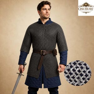 May include: A medieval chainmail shirt with a brown leather belt and a small pouch. The shirt is worn over a blue quilted tunic and sleeves. A sword is held in the left hand. The image includes the "Oak Heart Outfits" logo.