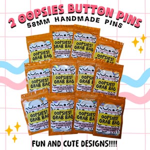 May include: A collection of orange grab bags containing button pins. Each bag is labelled "OOPSIES! GRAB BAG" and "FUN AND CUTE DESIGNS!!!!" The pins are 5.8cm in size and handmade.