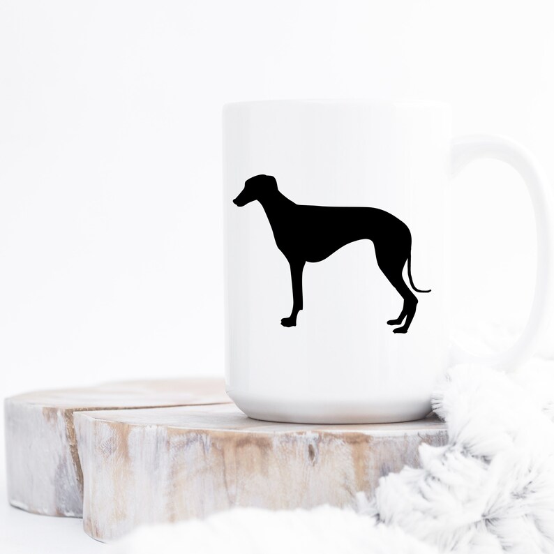 May include: White ceramic mug with a black silhouette of a Greyhound dog on the front.