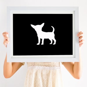 May include: A white silhouette of a chihuahua dog on a black background in a white frame.