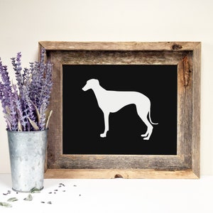 May include: A white silhouette of a greyhound dog on a black background in a rustic wooden frame.