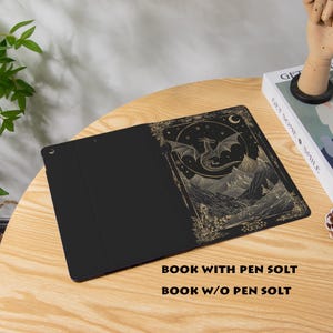 May include: Black tablet case with a gold dragon and mountain scene design. The case is open, revealing the interior. The text "BOOK WITH PEN SOLT" and "BOOK W/O PEN SOLT" is visible.