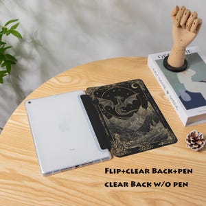 May include: An iPad with a clear case and a black cover featuring a dragon design. The cover is open, revealing the screen. The text "FLIP+CLEAR BACK+PEN" and "CLEAR BACK W/O PEN" is visible.